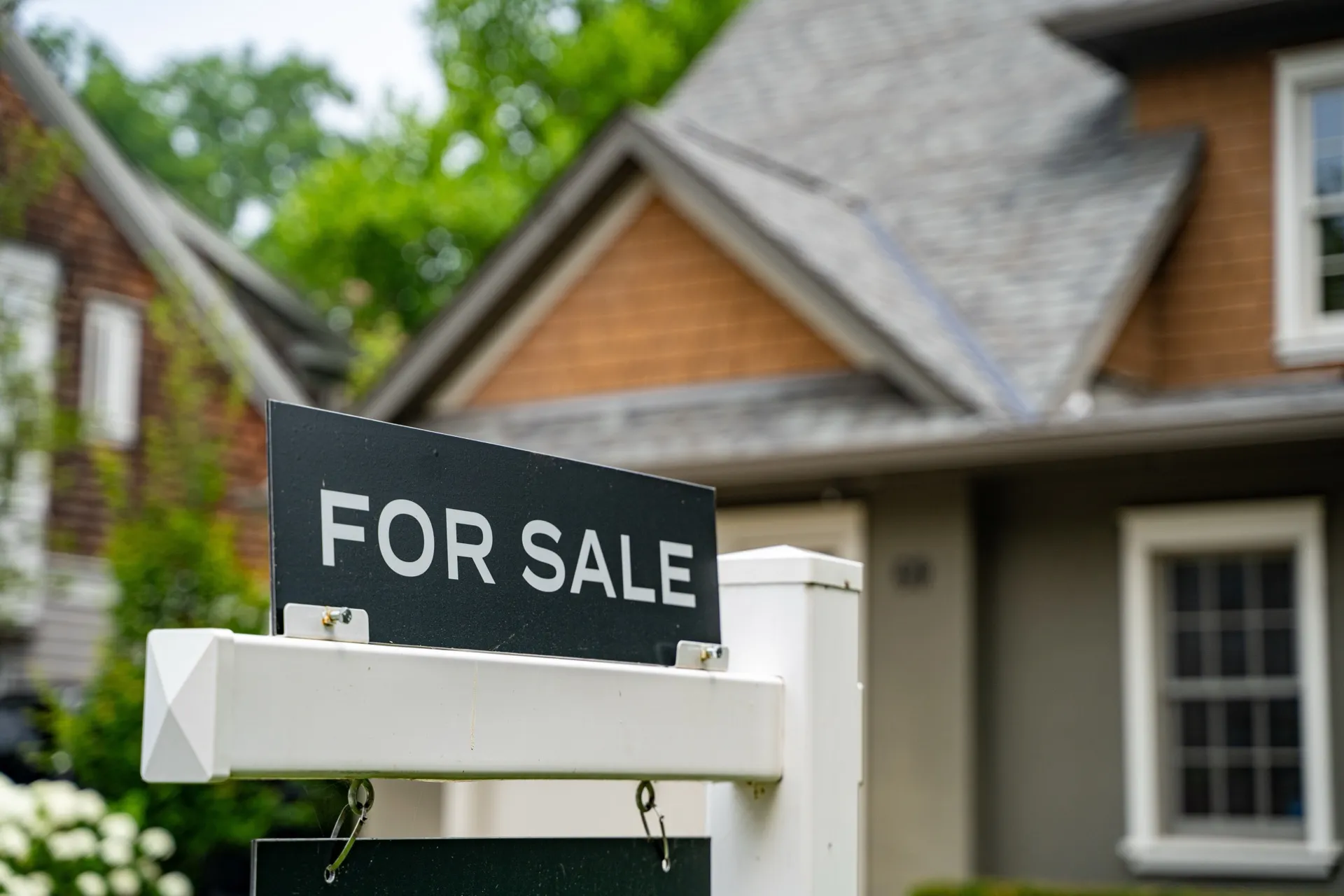 For sale sign in front of suburban home ready for pre-listing appraisal